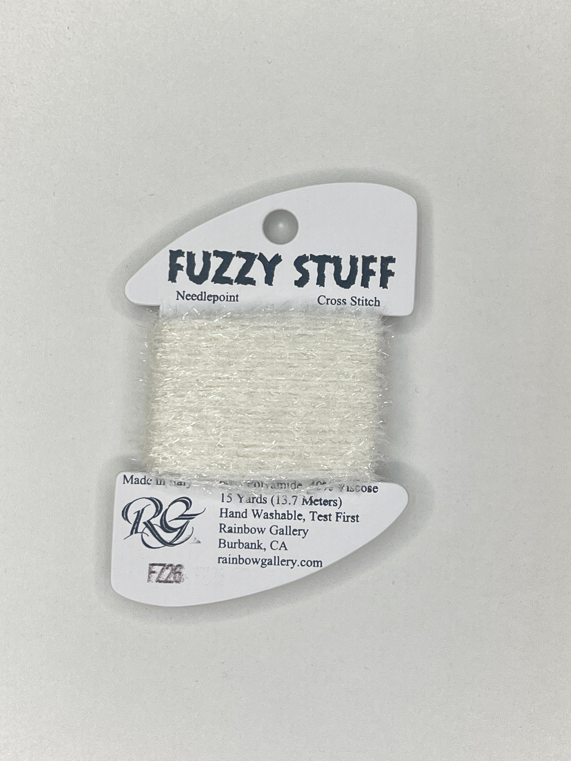 Spool of white embroidery floss with 'Fuzzy Stuff' label on a light gray background