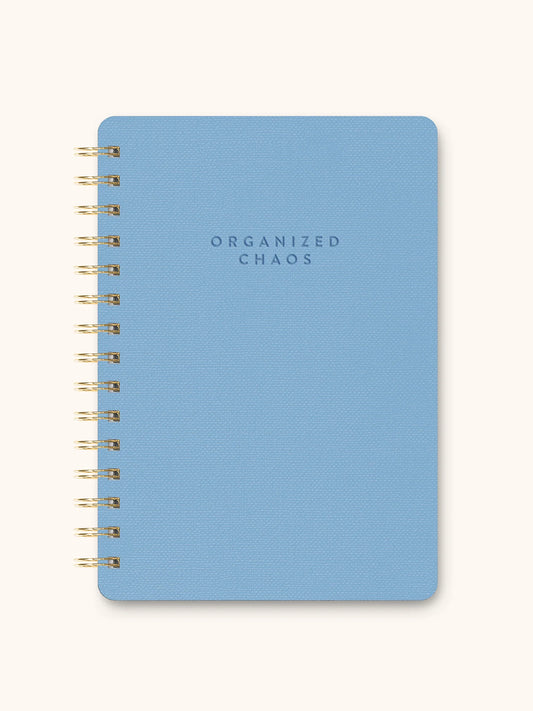 Blue notebook with 'ORGANIZED CHAOS' text on a white background