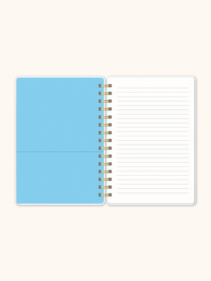 Open notebook with a blue cover and lined pages on a white background