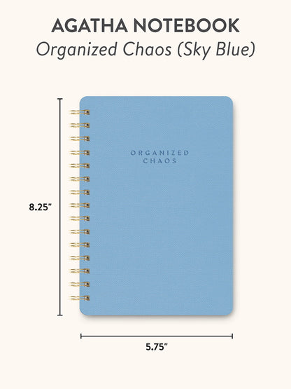 Blue notebook with 'Organized Chaos' text and dimensions on a white background