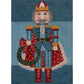 Decorative needlepoint of a character holding a wreath on a blue background