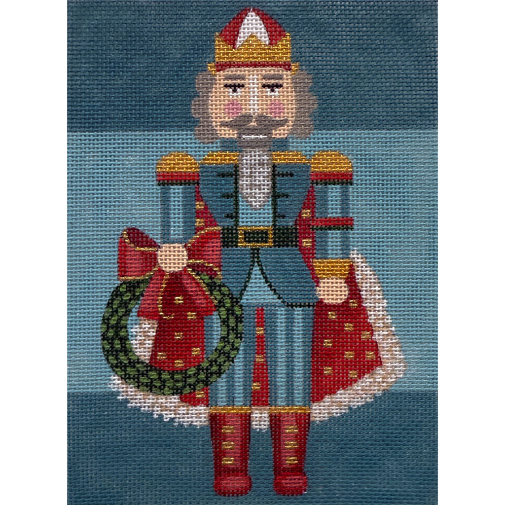 Decorative needlepoint of a character holding a wreath on a blue background