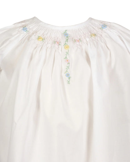 White blouse with floral embroidery on a white background