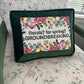 Floral-themed pillow with text on a floral-patterned chair