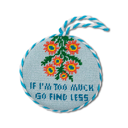 blue and white ornament says "if I'm too much go find less" on a white background