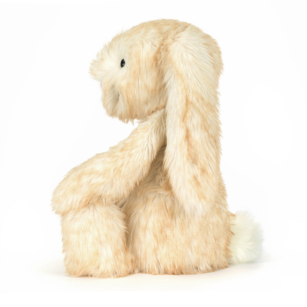 Plush toy dog with long fur on a white background