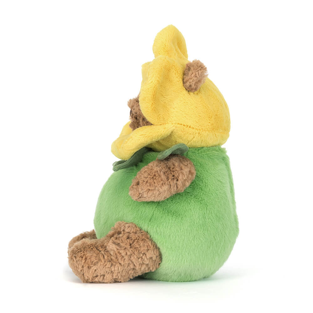 Plush toy resembling a character with a yellow hat and green body on a white background