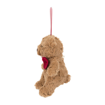 Plush dog toy with a red heart on a white background