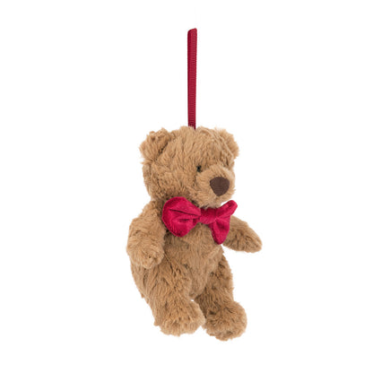 Plush teddy bear with a red bow tie on a white background