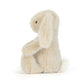 Fluffy beige bunny plush toy on a white background