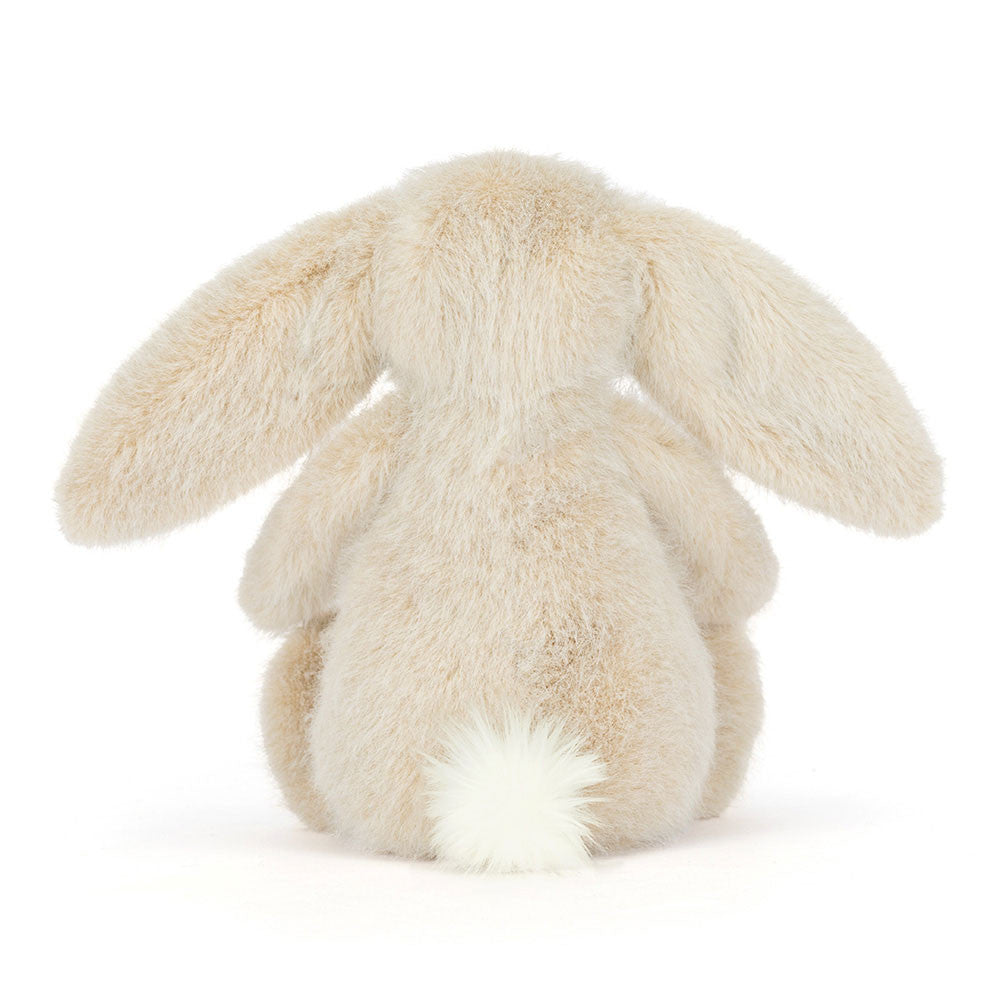 Fluffy beige bunny plush toy on a white background