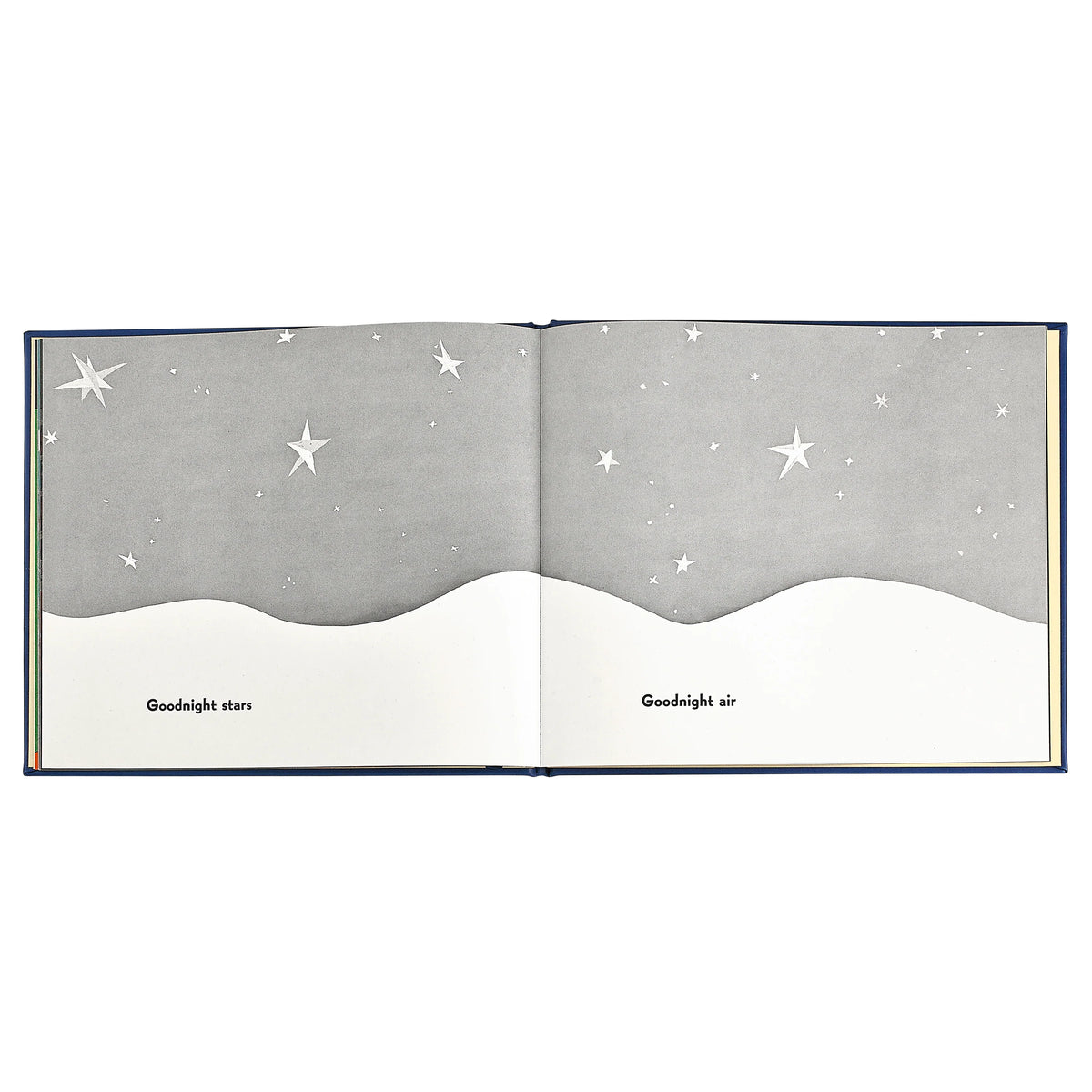 An open children's picture book spread showing a night sky scene with white stars on a gray background above a white wave-like horizon. The pages have the words 'Goodnight stars' and 'Goodnight air' printed at the bottom.