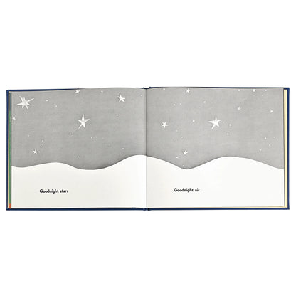 An open children's picture book spread showing a night sky scene with white stars on a gray background above a white wave-like horizon. The pages have the words 'Goodnight stars' and 'Goodnight air' printed at the bottom.