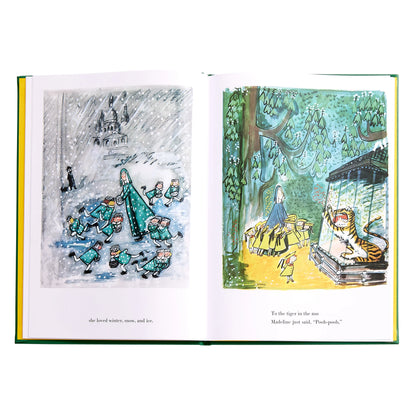 Open book with illustrated pages showing a snowy scene and a tiger in an enclosure.