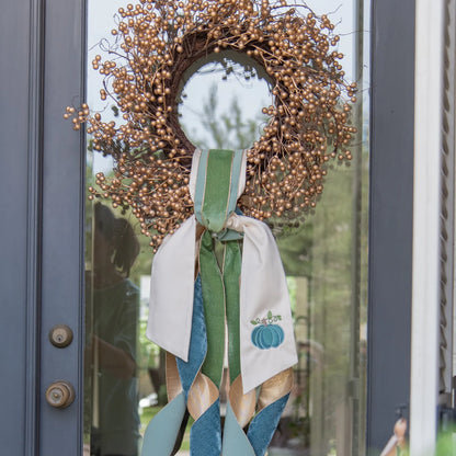 gold berry wreath on door with ribbons