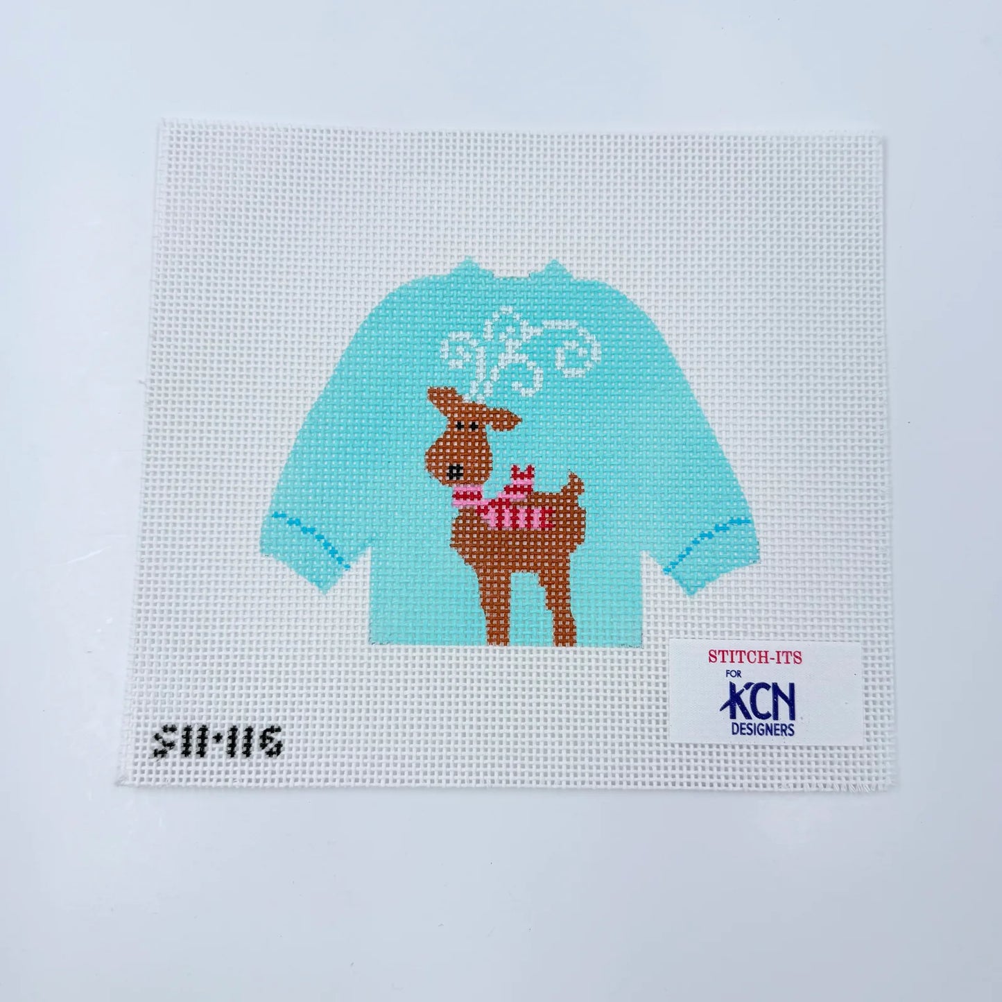 blue sweater needlepoint canvas with a reindeer design on it
