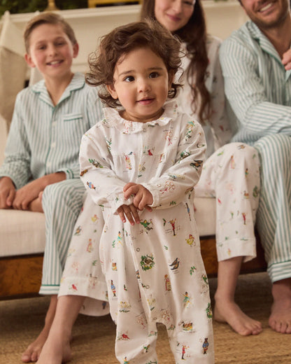Child in pajamas with family on a couch