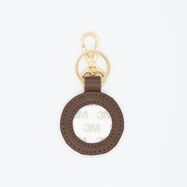 Brown keychain with gold ring on a white background