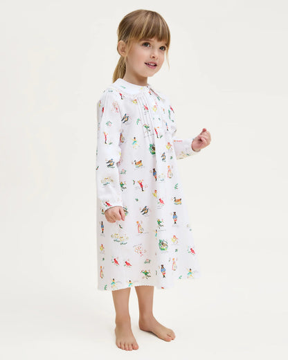 Child wearing a white robe with colorful animal print on a white background
