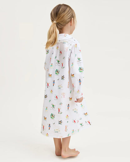 Child wearing a long-sleeve shirt with a colorful pattern on a white background
