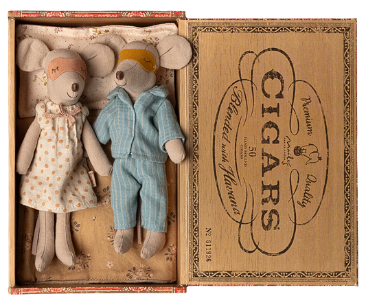 Two toy mice, a girl in a dress and a boy in overalls, inside an open cigar box with decorative text.