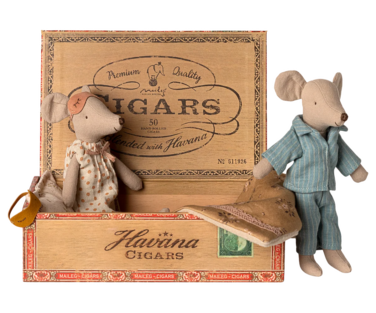 Two toy mice in a wooden Havaina Cigars box on a white background