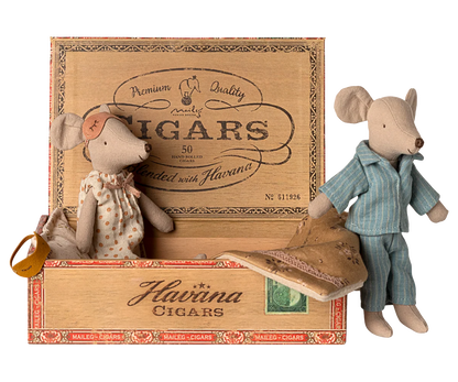 Two toy mice in a wooden Havaina Cigars box on a white background