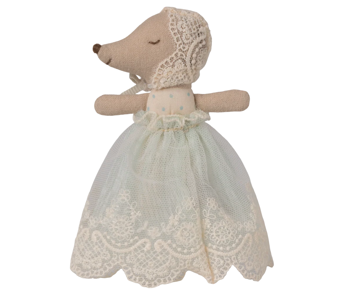 Stuffed animal toy with a lace dress on a white background