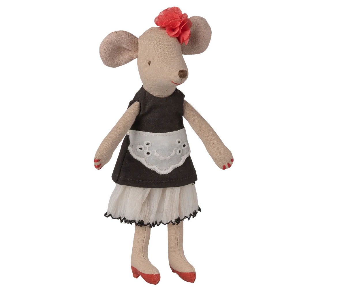 A plush mouse doll dressed in a dark brown apron top, white skirt, and red shoes, with a red flower in its ears, shown against a plain white background.