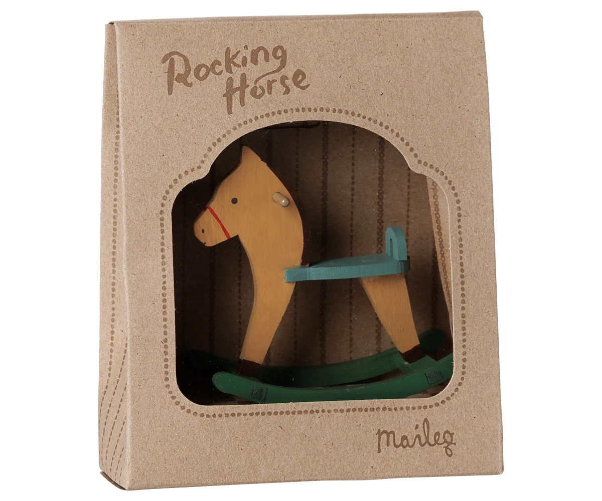 A wooden rocking horse toy in its original brown kraft paper packaging box, featuring a window cutout that displays the toy. The brand name 'Marley' is printed on the bottom right of the box.