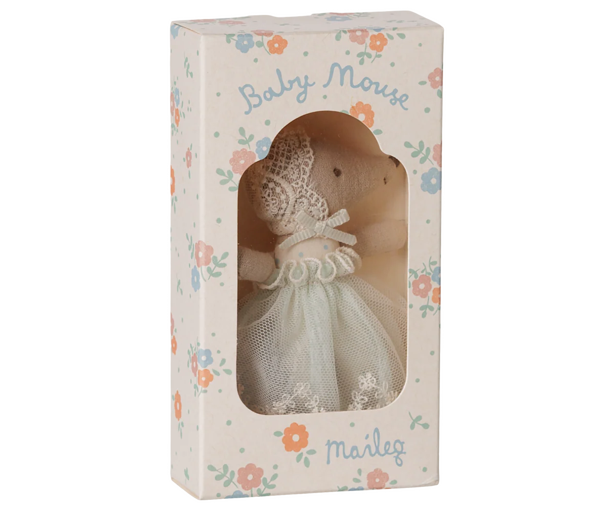 A baby mouse doll dressed in a white lace and tulle gown, presented inside its floral-patterned packaging box with the name 'Marig' printed on it.