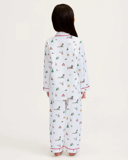 Person wearing a white pajama set with colorful patterns on a white background