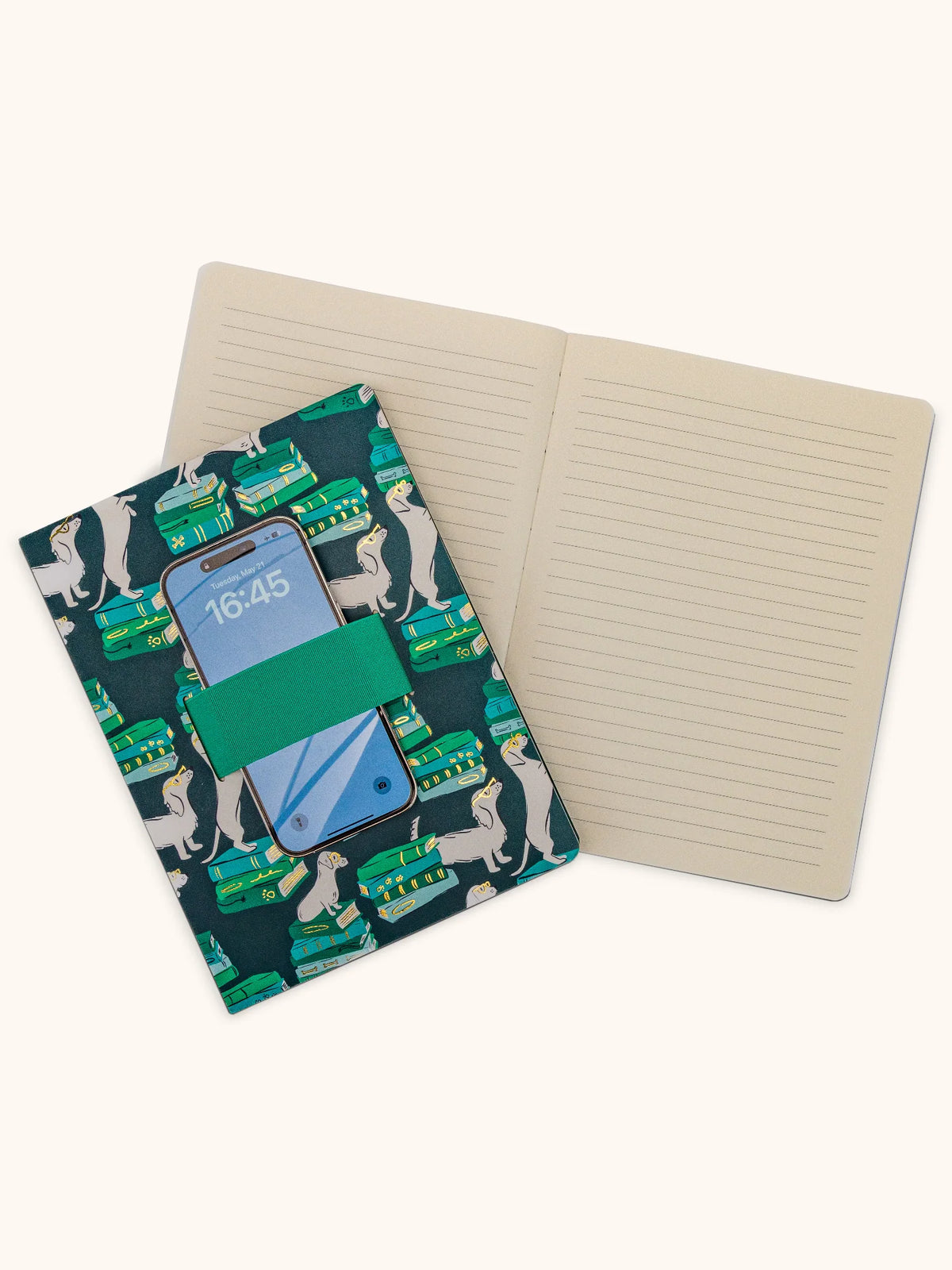 Notebook with a phone case on top featuring dog illustrations.