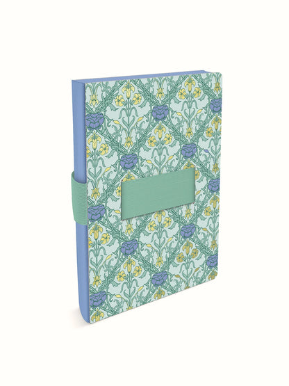 A hardcover notebook featuring a floral pattern in sage green, light blue, and yellow, with a matching sage green elastic closure band and a blank green label on the front.