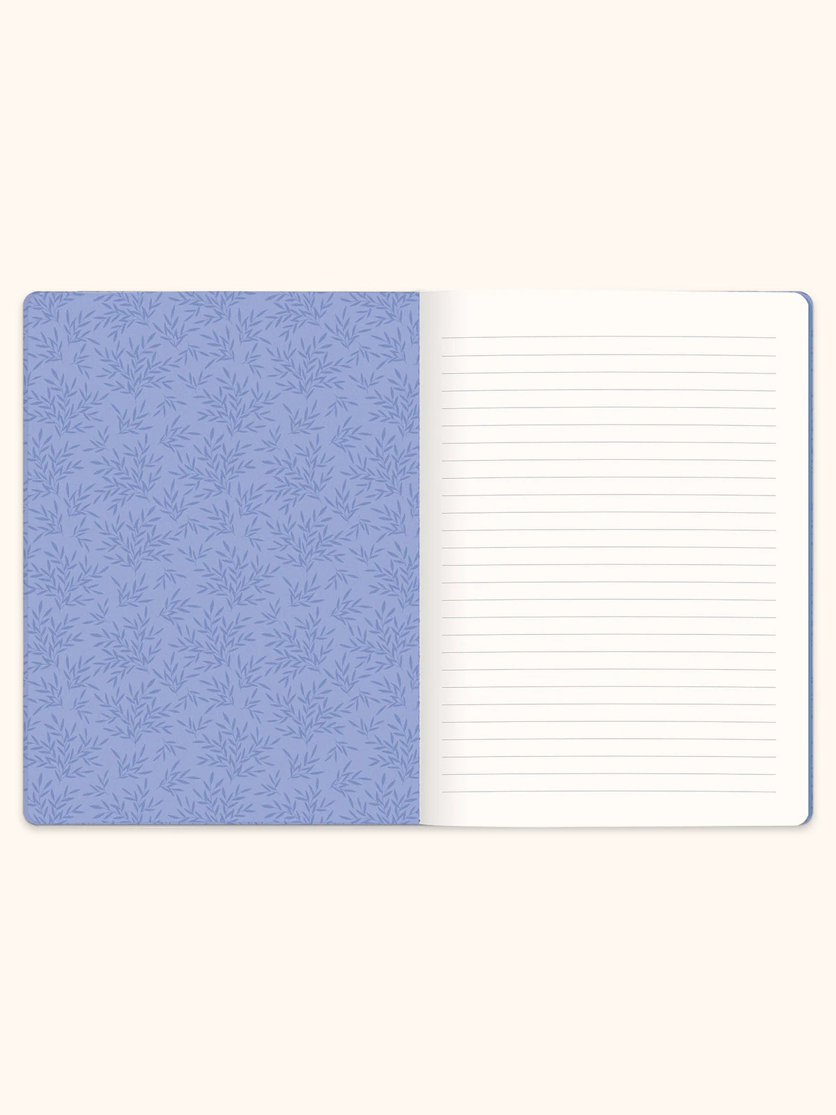 An open lined notebook with a light blue patterned cover on the left and blank white lined pages on the right, shown against a warm off-white background.