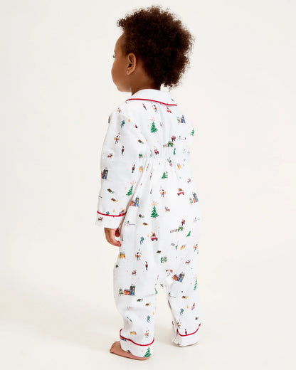 Child wearing a Christmas-themed onesie on a white background
