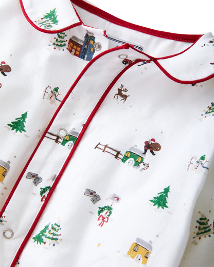 Close-up of a baby outfit with Christmas-themed pattern on a white background