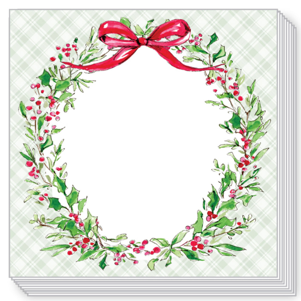 A stack of square greeting cards or paper products shown on a white background. The top card features a watercolor-style holiday wreath with green leaves, red berries, and a red bow on a pale green plaid background.