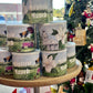 Stack of Moultrie Munch cat food cans on a wooden stand with a Christmas tree in the background.