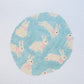 needlepoint pattern of bunnies on a light blue background