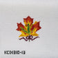 Embroidered maple leaf design on fabric with a visible brand label.