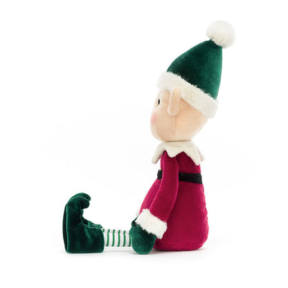 Plush toy elf with green hat and red outfit on a white background