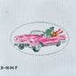Cross-stitched pink car with flowers on a white fabric background