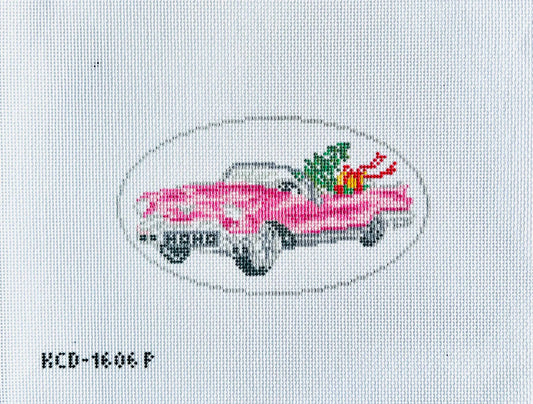 Cross-stitched pink car with flowers on a white fabric background