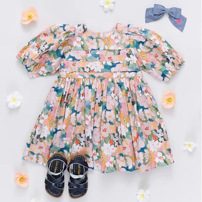 Floral dress with matching shoes and headband on a light background
