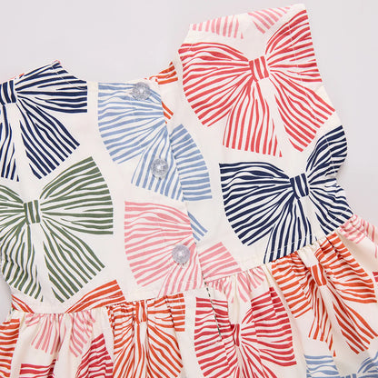 Colorful bow-patterned fabric swatches on a light background
