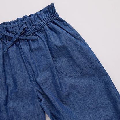 Blue denim pants with an elastic waistband on a light gray background