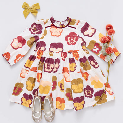 Floral dress with matching accessories on a light gray background