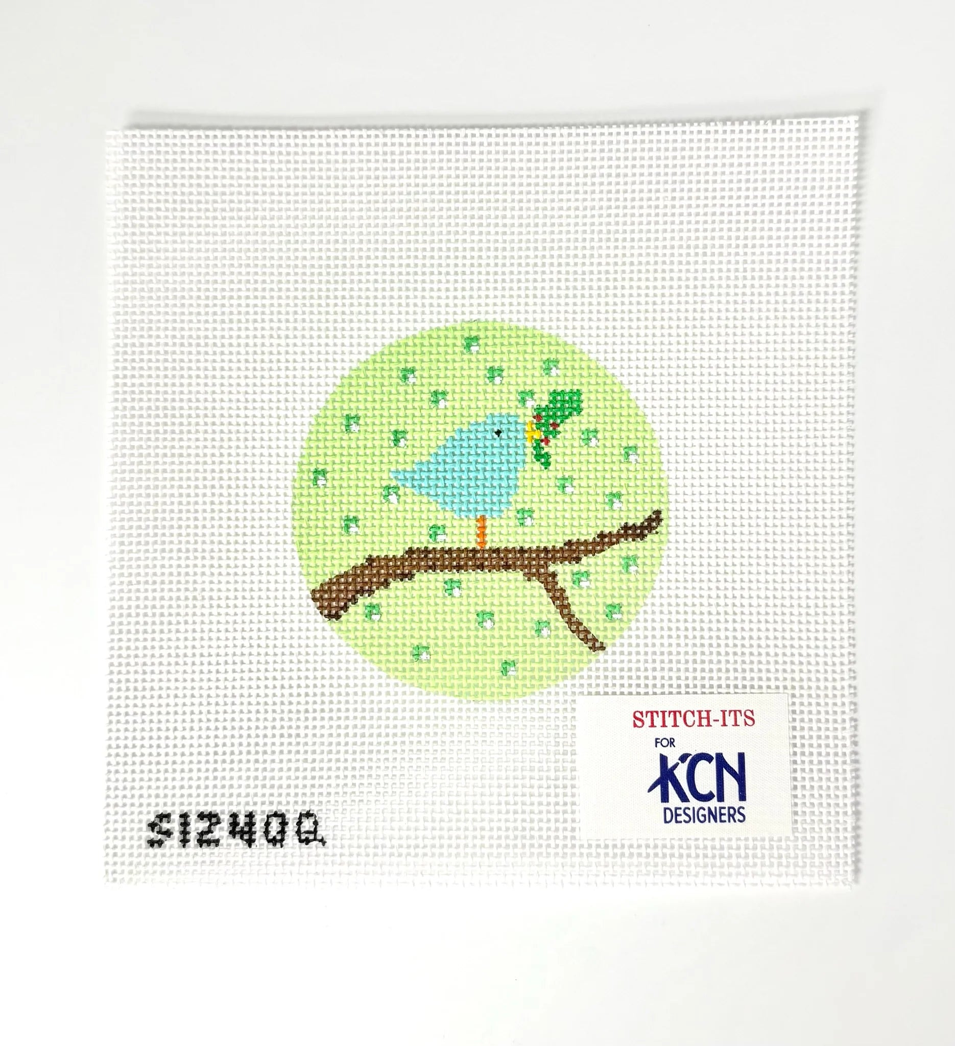 Needlepoint design of a blue bird on a branch with 'KCN Designers' branding.