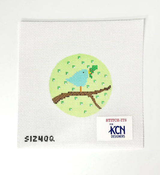 Needlepoint design of a blue bird on a branch with 'KCN Designers' branding.
